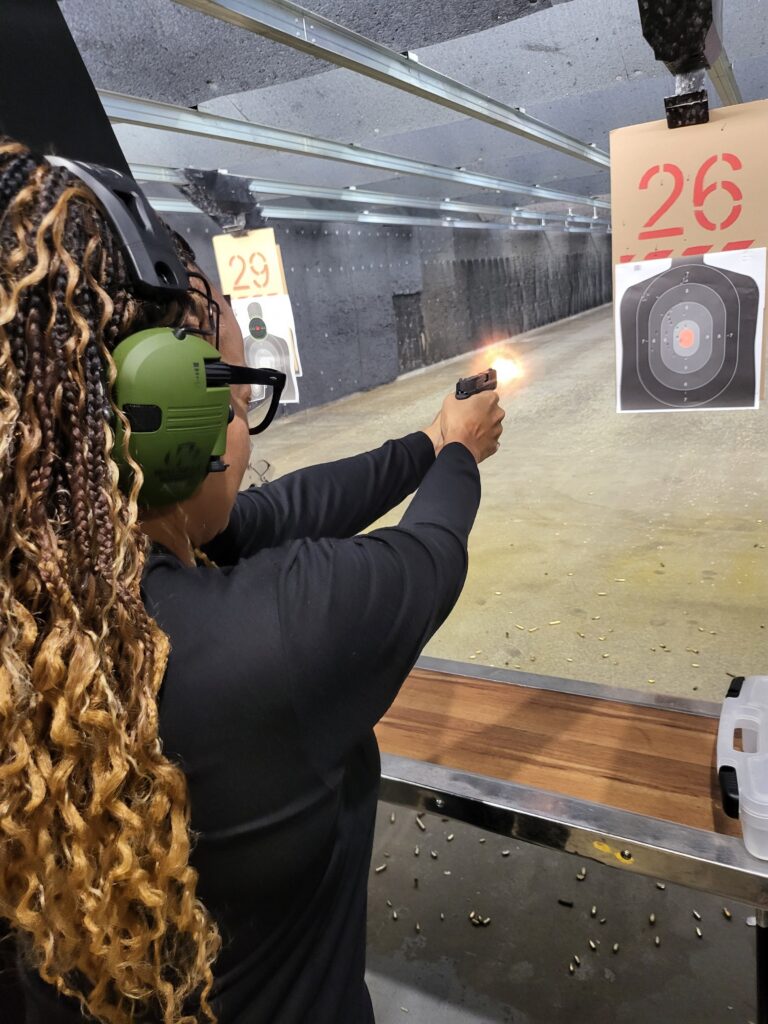 Student receiving hands-on firearms training at the range